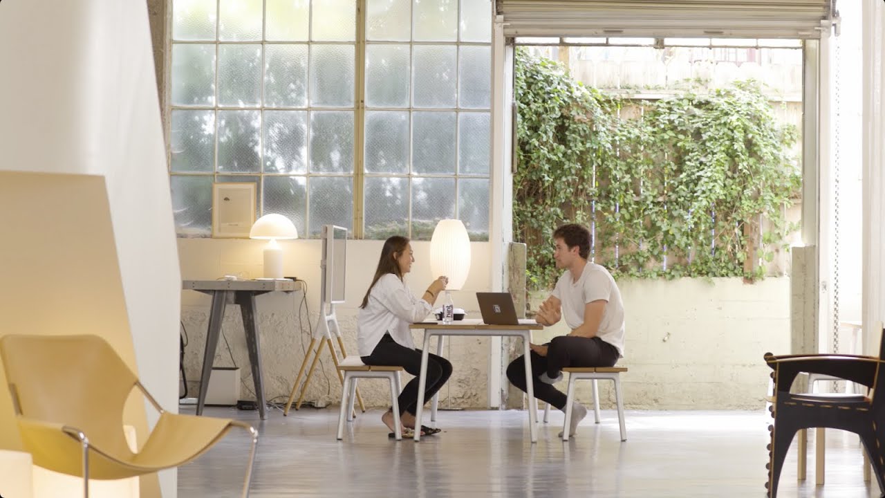 Two people seated at a table talking